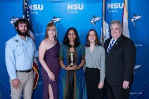 Dr. Aarti Raja, 2023 Professor of the Year, holds her STUEYs award with members of the Nature Club and Ron Chenail, Provost of NSU.COURTESY OF JAROD JOHNSON